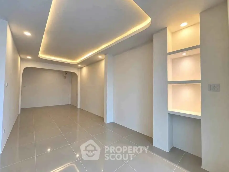 Modern minimalist interior with recessed lighting and sleek tile flooring