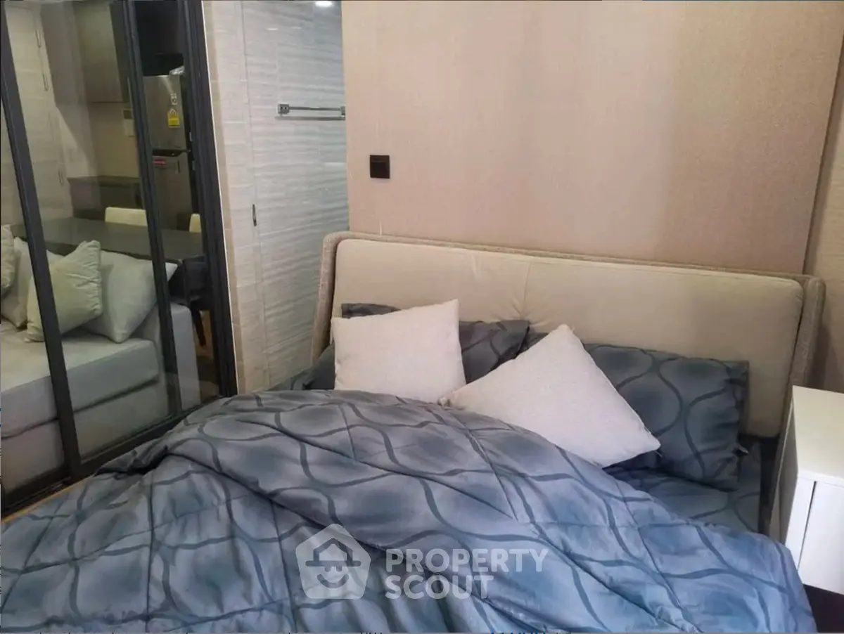 Cozy bedroom with modern decor and comfortable bedding in a stylish apartment.