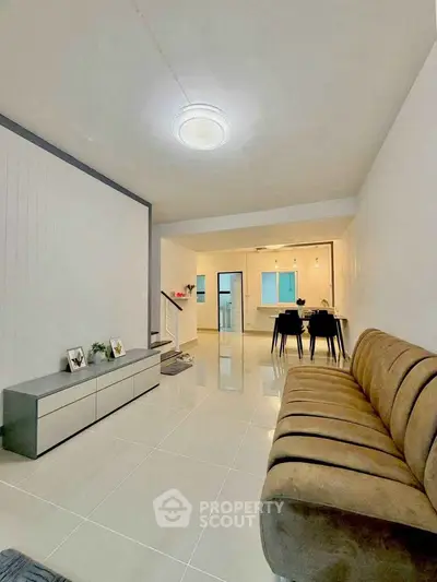 Spacious modern living room with sleek furniture and open dining area