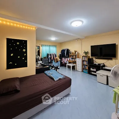 Spacious bedroom with modern decor and ample storage in a cozy apartment.