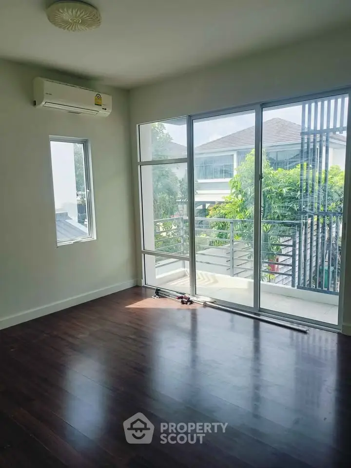 Bright empty room with large windows and balcony view, perfect for customization.