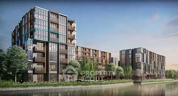 Modern riverside apartment buildings with lush greenery and scenic views.