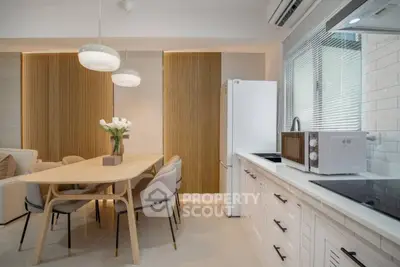 Modern kitchen and dining area with sleek design and natural light