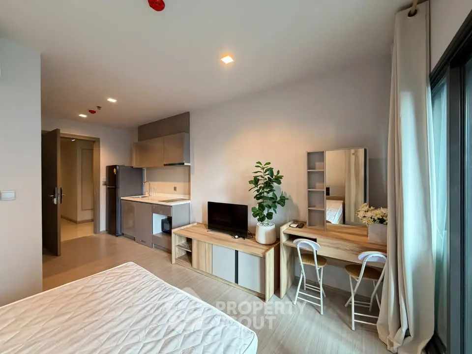 Modern studio apartment with open layout, featuring a cozy living area, kitchenette, and stylish decor.