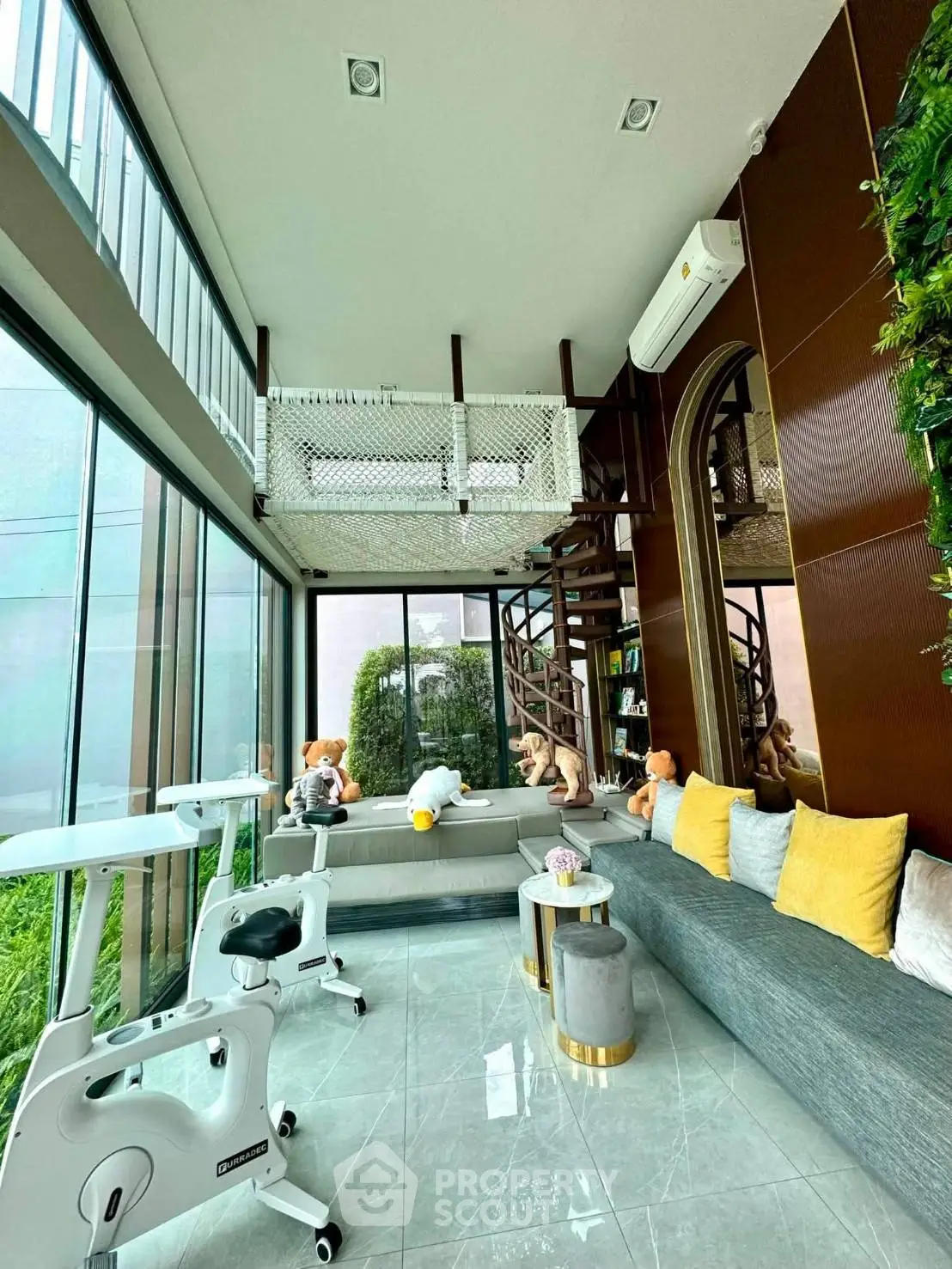 Modern living room with high ceilings, large windows, and stylish decor in a luxurious home.