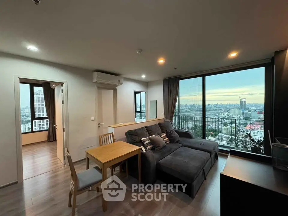 Modern living room with panoramic city view and cozy seating area