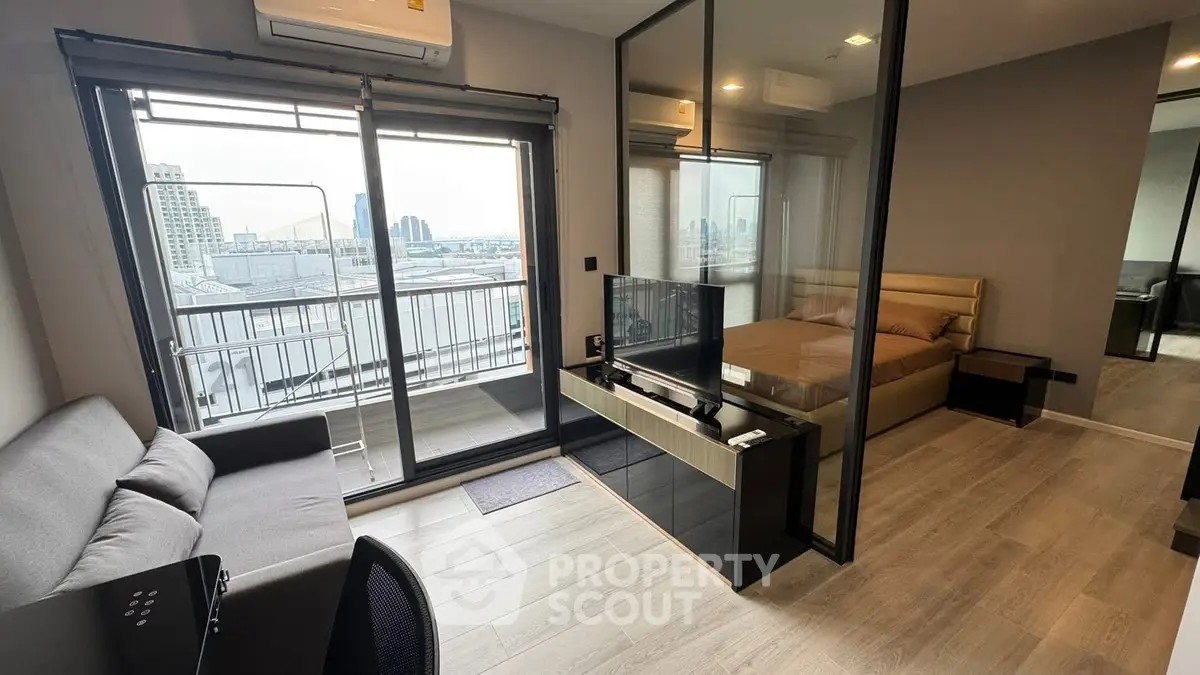 Modern condo with glass partition, cozy living area, and city view balcony.