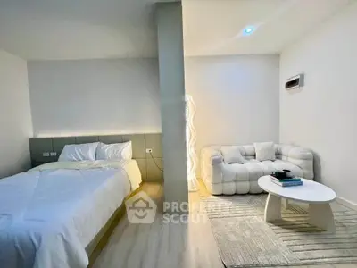 Modern bedroom with cozy seating area and stylish decor