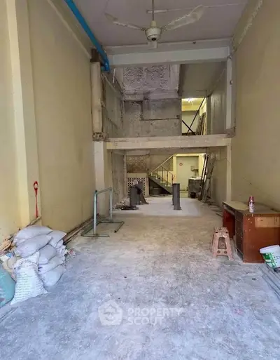 Spacious unfinished interior space with high ceiling and potential for customization.