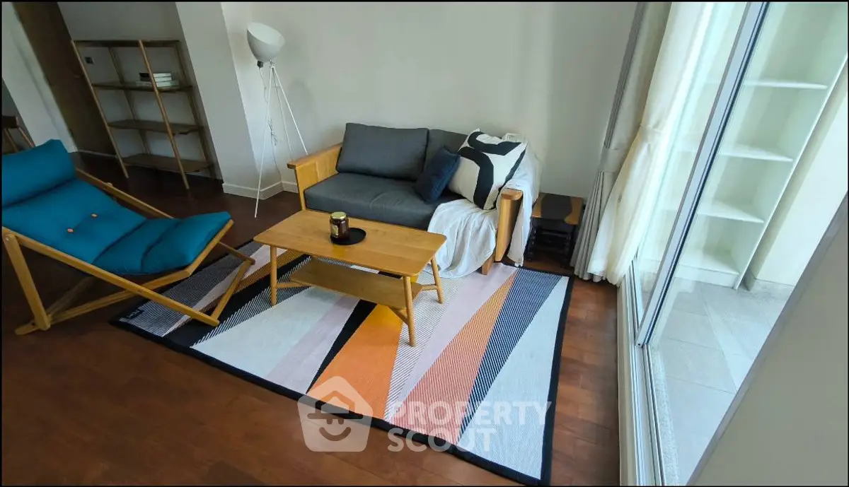 Stylish living room with modern furniture and large window for natural light.