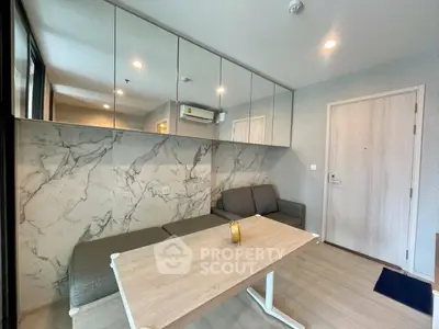 Modern living room with stylish marble accent wall and sleek furniture