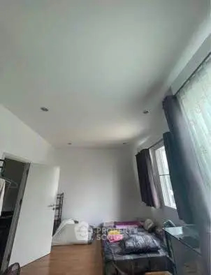 Spacious bedroom with natural light and minimalist decor