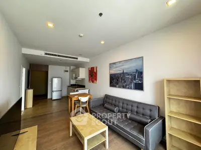 Spacious modern living room with stylish furniture and open kitchen layout in a contemporary apartment.