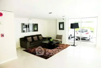 Modern living room with sleek furniture and large window view