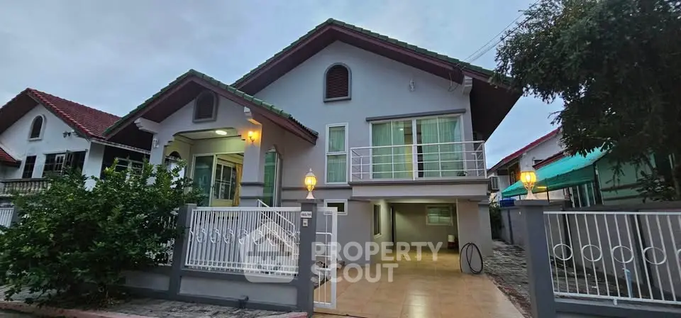 Charming two-story house with gated entrance and spacious driveway in a serene neighborhood.