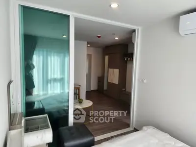 Modern bedroom with sliding glass door and cozy interior design