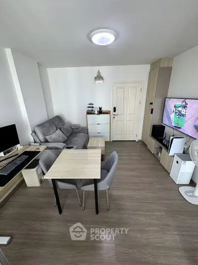 Modern living room with stylish furniture and entertainment setup, perfect for relaxation and productivity.