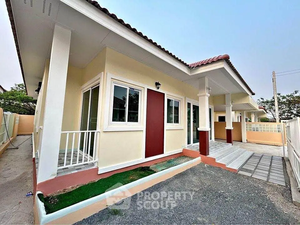 Charming single-story home with modern exterior and spacious driveway.