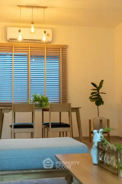 Modern living room with stylish furniture and natural light, featuring a cozy seating area and elegant decor.