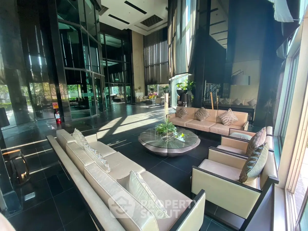 Luxurious modern lobby with elegant seating and floor-to-ceiling windows in a high-end building.