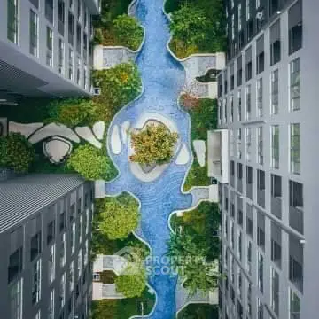 Stunning aerial view of modern apartment complex with lush garden and winding pathways.