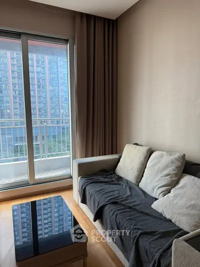 Modern living room with cozy sofa and balcony view in urban apartment
