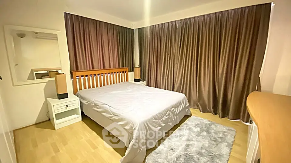 Spacious bedroom with elegant wooden furniture and cozy ambiance