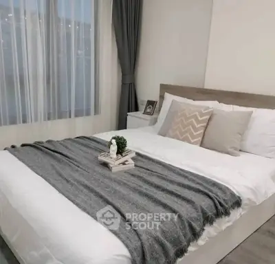 Cozy bedroom with modern decor and large window for natural light