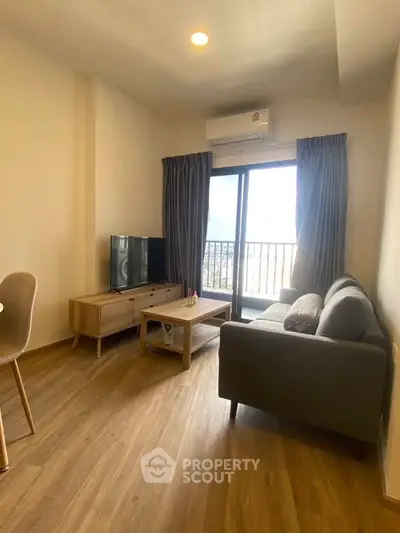 Modern living room with wooden flooring and balcony view