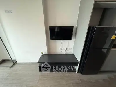 Modern living room with sleek TV setup and stylish black furniture
