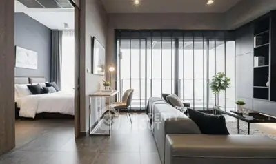 Modern open-plan living room with sleek furniture and large windows