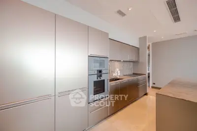 Modern kitchen with sleek cabinetry and built-in appliances in a luxury apartment.