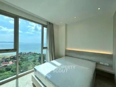 Luxurious bedroom with stunning ocean view and floor-to-ceiling windows