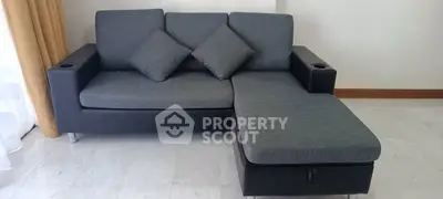 Modern living room with stylish L-shaped sofa and elegant decor