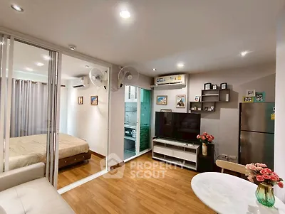 Modern apartment interior with open living room, bedroom, and kitchen featuring sleek design and cozy ambiance.