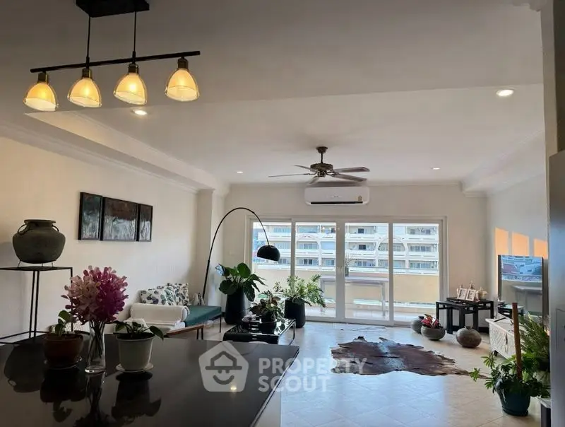 Spacious living room with modern decor and large windows offering ample natural light.