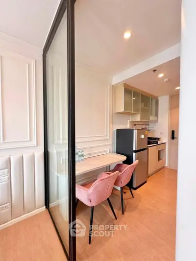 Modern kitchen with open layout and stylish dining area in a contemporary apartment.