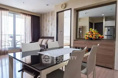 Modern dining area with elegant table, chairs, and balcony view in a stylish apartment.