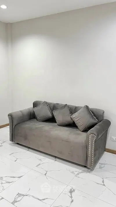 Modern living room with stylish gray sofa and elegant marble flooring