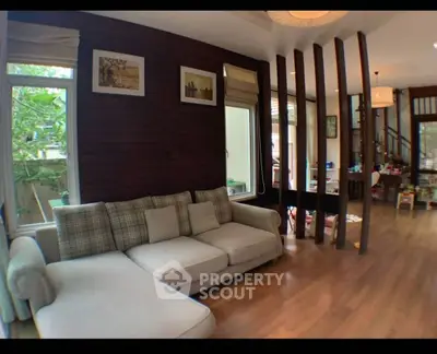Spacious living room with modern decor and large windows for natural light.