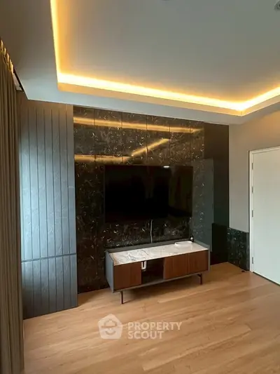 Modern living room with sleek TV unit and ambient lighting
