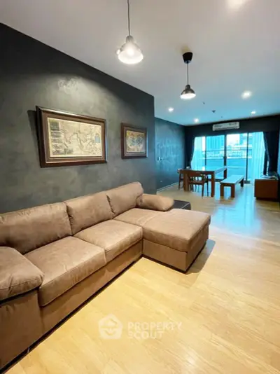 Spacious modern living room with stylish decor and large windows offering city views.