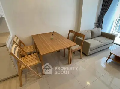 Modern living room with wooden dining set and cozy sofa