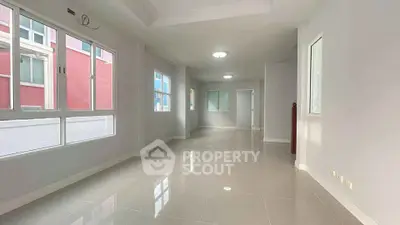 Spacious and bright interior with large windows and glossy tiled floors