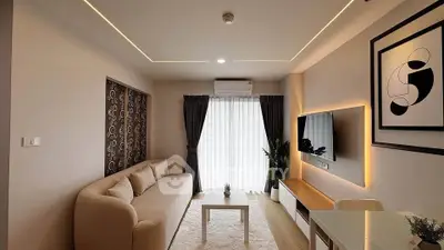 Modern living room with stylish decor, cozy sofa, and wall-mounted TV, perfect for relaxation and entertainment.