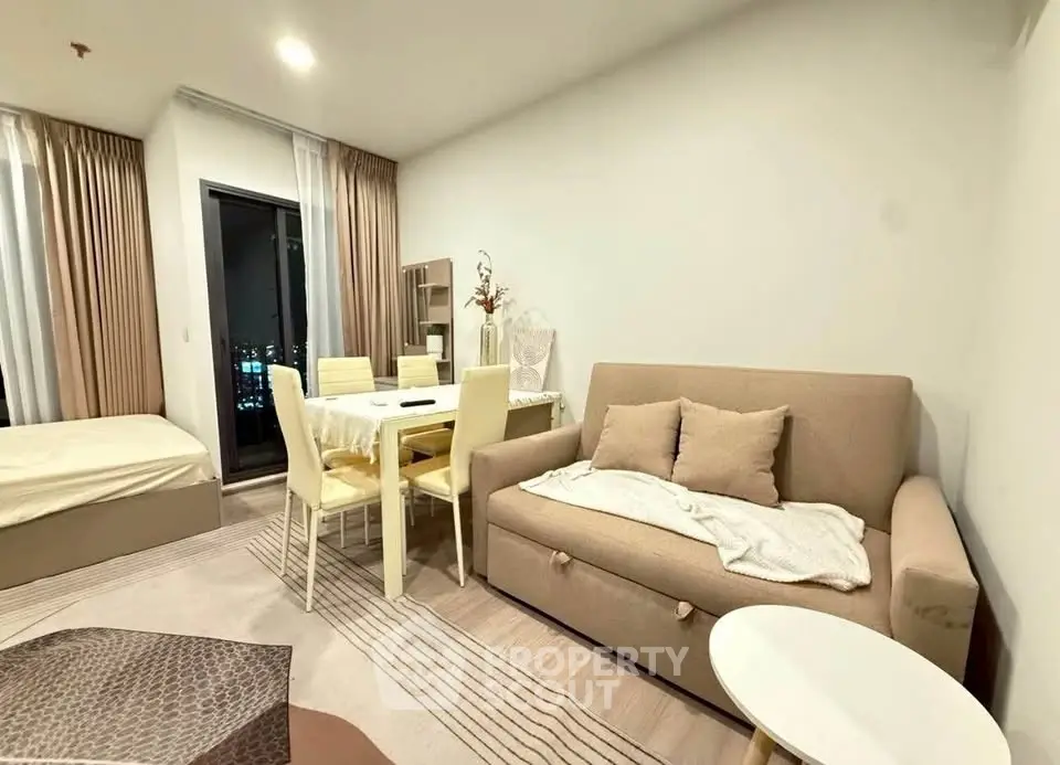 Modern living room with cozy sofa and dining area in open layout apartment