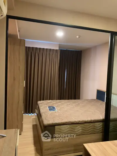 Cozy bedroom with modern furnishings and warm lighting, perfect for relaxation and comfort.