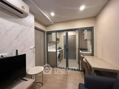 Modern living room with open kitchen and stylish decor in a cozy apartment.