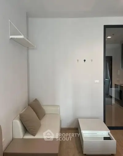 Modern minimalist living room with white sofa and sleek coffee table