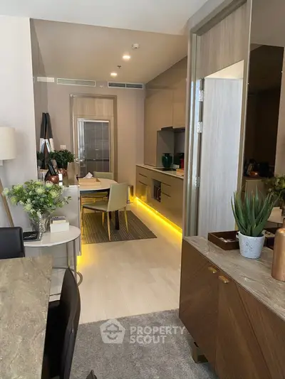 Modern open-layout kitchen and dining area with stylish decor and ambient lighting.